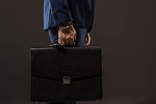 business-man-holding-briefcase-as-a-psap-employee-showing-how-next-generation-9-1-1-makes-their-job-more-efficient