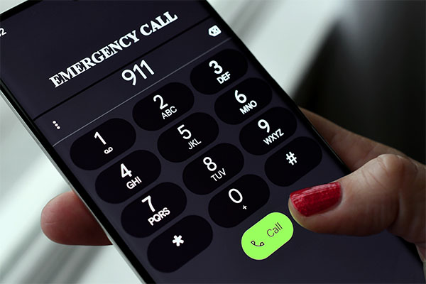womans-hand-holding-phone-dialing-9-1-1-for-NG9-1-1-Emergency