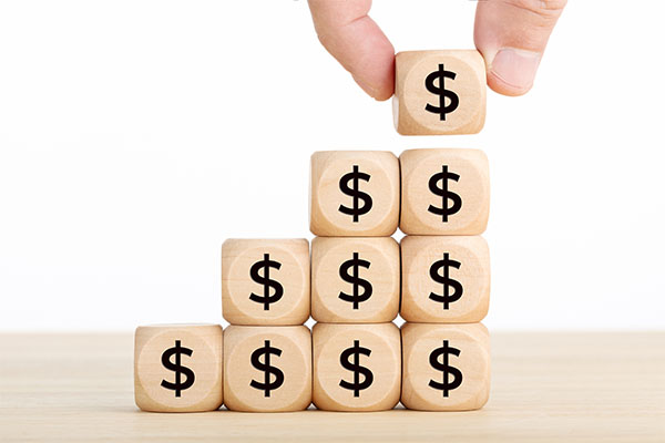 wooden-blocks-with-dollar-signs-stacking-to-make-steps-representing-growth-in-next-generation-9-1-1