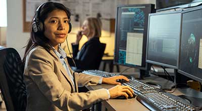 next-generation-911-call-taker-at-computer-dressed-professionally