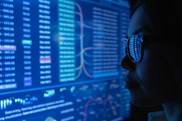 woman-cybersecurity-worker-wearing-glasses-and-close-up-of-her-face-and-computer-screen-with-code-showing-ng9-1-1-cybersecurity-and-protection