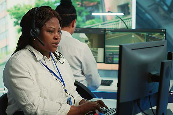 woman-sitting-at-computer-doing-ng9-1-1-training-and-education-to-ensure-they-are-prepared-for-emergency-scenarios